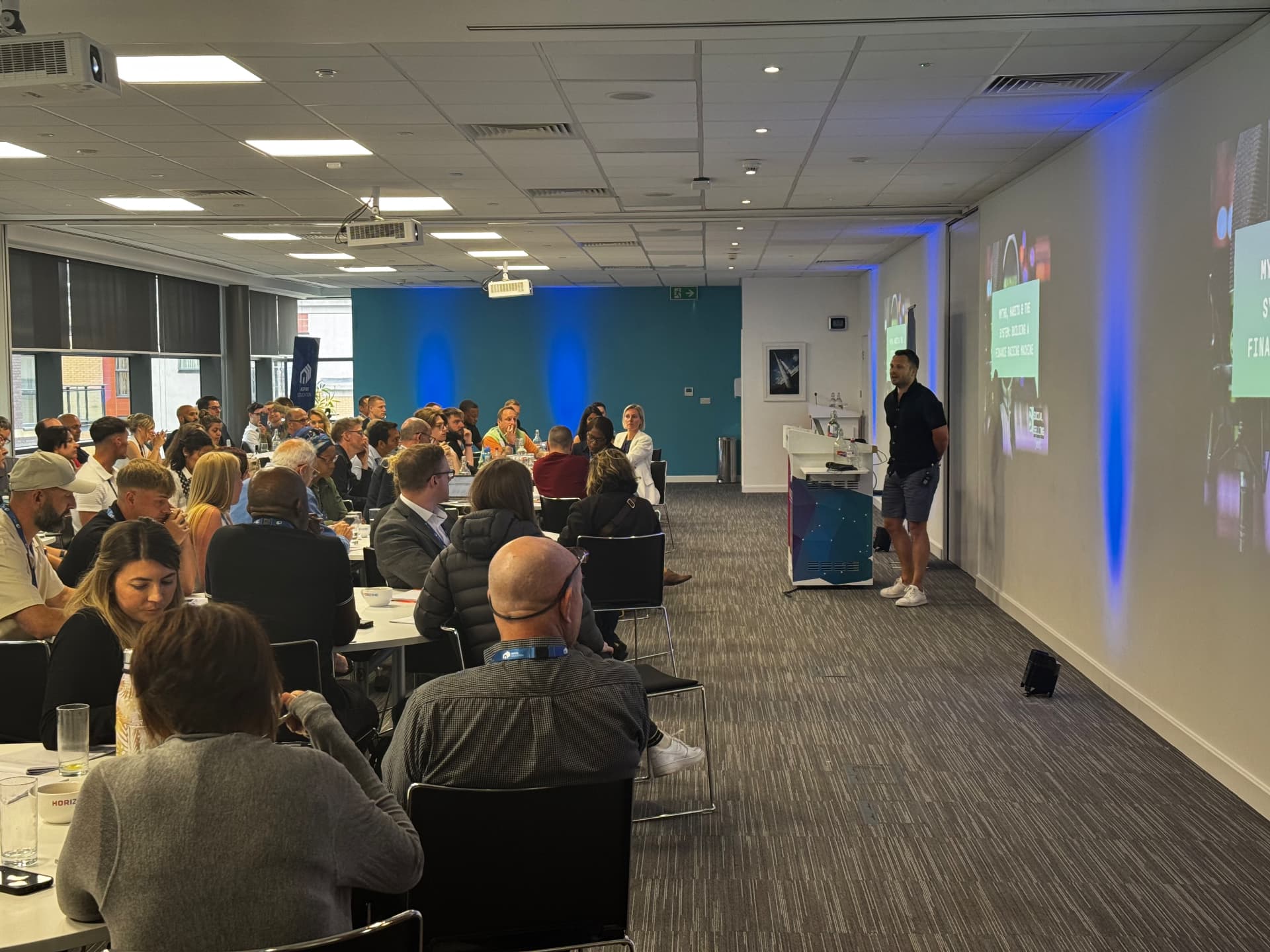 Chris Taylor speaking to a full room of business owners
